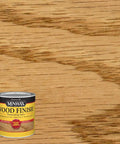 Slick Top Shelf Oil Based Wood Stain In Warm Ipswich Pine Shade shows smooth wood grain on a wood surface with can.