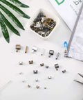 All In One Zipper Repair Kit With Metal Insertion Pins, Latch Sliders And Stopper Sets, 60 Pieces on a white surface with tools