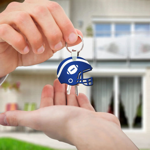 Close-up of person handing over blue helmet-shaped keychain from Helmet Shape Sublimation Keychain Blanks Kit, 20 Pieces