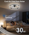 Modern 24 Inch Low Profile Ceiling Fan With Dimmable LED Light And Wireless Remote Slick Black Design above a bed, dim light ambiance.
