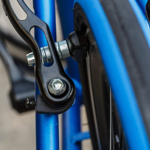 Close-up of V Brake Pads 70mm Set With Hex Nuts And Spacers For Bicycle installed on blue bike frame, rear view.