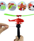 Close-up of a red helicopter toy with green blades from Colorful Helicopters And Airplanes Set With Launcher, 20 Flying Toys.