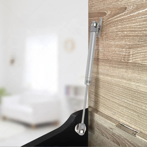 Two Pack Soft Close Toy Box Hinges With 100N Gas Strut installed on a wooden cabinet, showing hinge closure mechanism.
