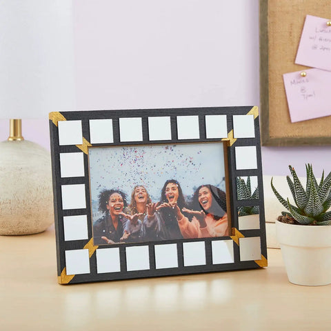 Picture frame with 120 Pack Mini Square Mirror Tiles 1x1 Inch For Mosaic Art And Crafts on a desk with plants