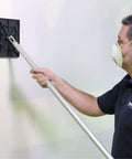 Person using Pro Drywall Sander Head 540 No Flip Design Quick Change System Made in USA by Trim Tex on a wall for smooth finish