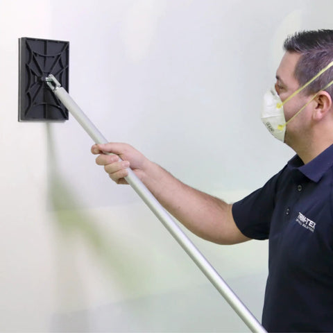 Person using Pro Drywall Sander Head 540 No Flip Design Quick Change System Made in USA by Trim Tex on a wall for smooth finish
