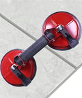 No Sweat Heavy Duty Vacuum Suction Cups Featuring Dual Claw Grip Tool For Easy Glass Handling Tile Work And Windshield Swaps on tiled surface.