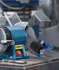 Top Shelf Seven One Half Inch Grinding Wheel Dresser With No Sweat Straight Handle next to a bench grinder for restoring abrasive wheels.