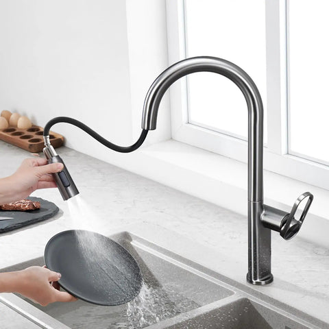 TXGJWRA Green Pull-Faucet with 360-Degree Swivel Spray Head, Single Hole Sink Mixer in use, washing a plate.