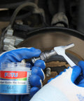 Applying 661 guide pin grease from Complete Brake Caliper Grease Kit for quiet, smooth braking performance