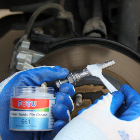 Applying 661 guide pin grease from Complete Brake Caliper Grease Kit for quiet, smooth braking performance