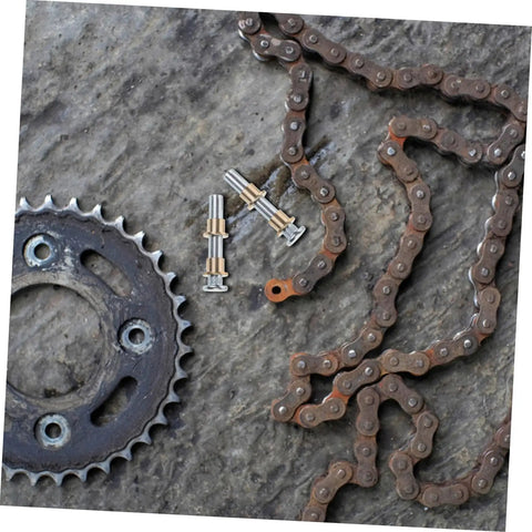 Rusted chain and sprocket with small metal parts, related to Door Hinge Repair Kit Pin And Bushing For Automotive Door Hardware