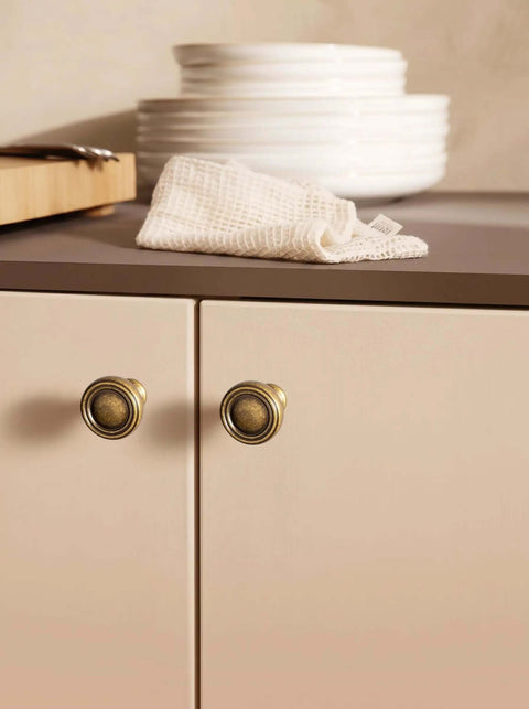 6 Pack Antique Brass Zinc Alloy Cabinet Knobs And Drawer Pulls For Kitchen Cabinets shown installed on beige doors