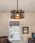 Kickass 14 Inch Black Farmhouse Pendant Light With Plug In Dimmable Switch And Adjustable Woven Cord For Kitchen Island Or Dining Room Heavy Oak Wood And Metal Cage Fixture Giving Major Rustic Vibes That Goes Hard On Sloped Ceilings hanging in a room with a warm glow.