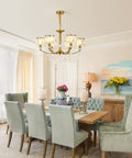 Gold Wagon Wheel Chandelier With 6 Lights, Clear Crystal Shades, in elegant dining room, Nordic Modern Mid Century design