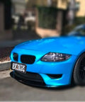 Blue car with Premium Universal License Plate Frame With Integrated Bumper Guard And Thick Rubber Shield protecting plate.