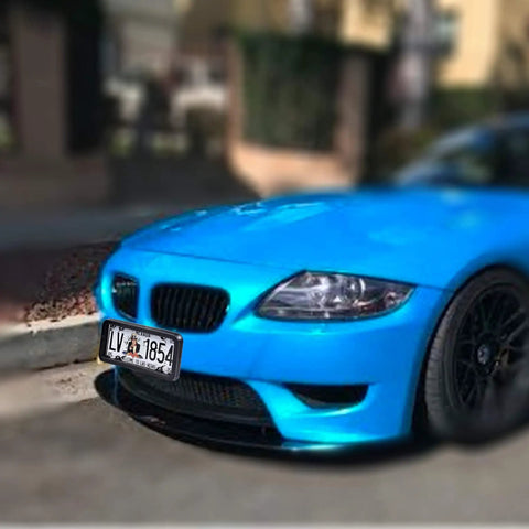 Blue car with Premium Universal License Plate Frame With Integrated Bumper Guard And Thick Rubber Shield protecting plate.