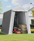 Heavy-Duty Portable Outdoor Storage Shed Tent 6x8x7 Ft With Roll-Up Zipper Door in a backyard, storing a lawn mower and wood