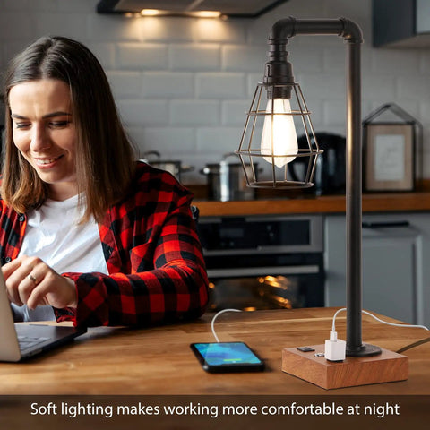 Woman using laptop beside Industrial Desk Lamp With Bulb Included, 3-Way Dimmable, Dual USB Ports And AC Outlet in kitchen.