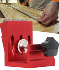 Pocket Hole Jig Set With Steel Bushings And Anodized Aluminum Body Delivers Precise 15 Degree Dowels For Woodworking, Cabinetry, And Furniture Assembly, Industrial Grade Durability, Reliable Accuracy, Ideal For Repeated Use In Shops shown in red with a woodworking setup in the background.