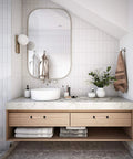 Modern bathroom vanity with white basin, marble countertop, round mirror, and wooden cabinet in a sleek design.