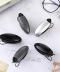 5-Piece Car Sun Visor Clip Holder Set For Glasses And Eyewear, Eyeglasses Mount And Card Clip in black, gray, and silver on table