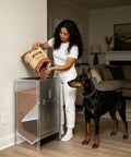 Woman pouring kibble into Built Tough Stainless Steel Dog Feeder For Large Breeds 50 Pound Automatic Kibble Dispenser.