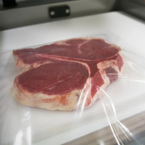 Raw steak in Chamber Vacuum Pouches 3 Mil Thick, 10 x 13 Inches, BPA Free Pre Cut Bags With Tear Notch for sealers.