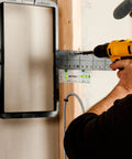 Person using a Nifty Tiny Handheld Magnetic Bubble Spirit Level With Clear Acrylic Measure Stick for wall alignment while drilling.