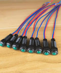 Green LED Indicator Pilot Light Kit For Panels 110VAC 8mm Mounting Hole Flame Retardant Plastic Shell 8 Pieces For Clear Status Signals And Emergency Alerts Easy To Install In Industrial Control Panels For Clear Status Alerts And Quick Diagnostics. Eight green panel pilot lights with red and blue wires.