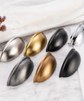 Assorted metal cabinet pulls including Brushed Gold Cabinet Pulls 3 Inch Hole Centers Bin Cup Handles Pack Of 10 shown on marble surface.