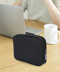 Compact Grab And Go Travel Case Organizer for Small Electronics and Accessories on a wooden table
