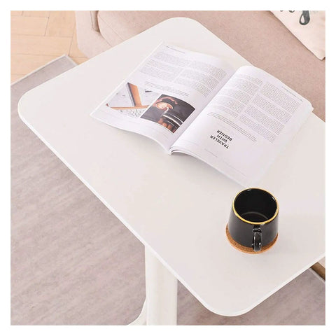 Built Different Overbed Table With Adjustable Height For Bedside Care And Work From Home Vibes with magazine and coffee cup.
