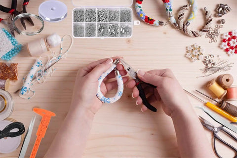 Hands using pliers from the All In One Jewelry Making Kit With Pliers, Findings, Beading Wires And Repair Tools For Adults And Beginners