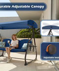 Woman relaxing on Three Seat Patio Porch Swing With Canopy And Adjustable Backrest, Outdoor Glider With Stand, Foldable Side Tray And Removable Pillows, Heavy Duty 800 Lb Capacity, Perfect For Balcony Garden Deck; blue canopy and pillows