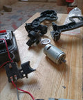 Beast 18V DC RS550 Style Motor with 12-Tooth Gear, 20500 RPM high-speed electric motor on wooden table with components