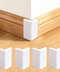 Thickened White Self Adhesive Rubber Corner Protectors Set Of 4, cushioned guard strips shown on a wooden baseboard corner.