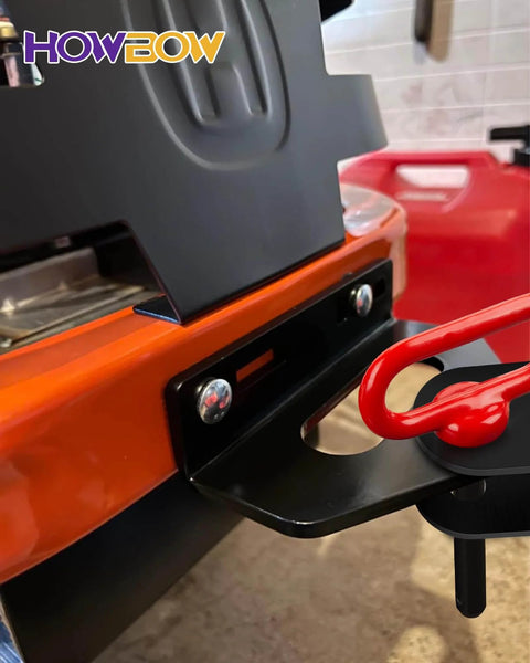 Close-up of Half Inch Trailer Hitch Pin And Clip With Rubber Coated Red Handle installed on orange tractor