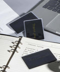 Pro Grade Thick Black Anodized Aluminum Business Cards 86x54mm 0.8mm Thick Set Of 15 With Frosted Protector Sleeves shown in office setup
