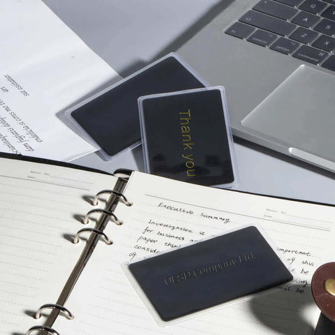 Pro Grade Thick Black Anodized Aluminum Business Cards 86x54mm 0.8mm Thick Set Of 15 With Frosted Protector Sleeves shown in office setup