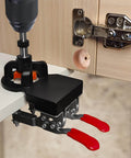 Concealed Positioning Hinge Hole Punch 35mm Door Hinge Jig With 2 Retaining Clips in use, mounted on wooden cabinet door for drilling.