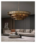 Next Level French Gray Glass Ceiling Pendant Light Sleek Round Chandelier with warm ambiance over modern living room sofa.