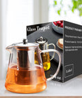 Stovetop Safe Glass Teapot 550ml With Removable Stainless Steel Infuser, shown next to box. Borosilicate Glass Tea Kettle ideal for camping.