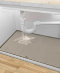 Under Sink Mat 34x22 Silicone Taupe Waterproof Flexible Rectangular With Drain Hole For Kitchen And Bathroom Fits 36 Inch Cabinets Leak Proof No Mess Easy Clean Durable Silicone Mat placed under leaking kitchen sink