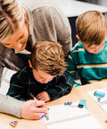 Children using Conductive Ink Pen For DIY Circuits With Silver Ink, Non-Toxic And Easy To Use, writes on any surface from paper to plastic.