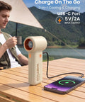 10000mAh Portable Handheld Fan With USB Rechargeable Power Dope Mini Turbo Breeze on table charging phone, outdoor scene