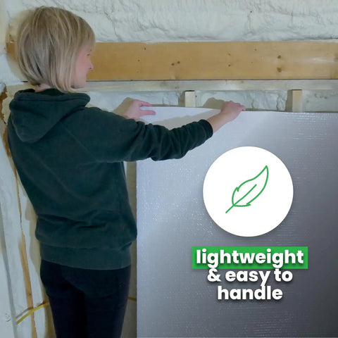 Person handling Double Bubble Reflective Foil Insulation Roll 48 X 75 Feet, lightweight material for easy installation.