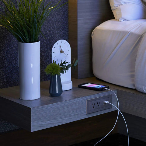 Radiant Furniture Power Center with USB and Recessed Power Strip 2 Outlets on nightstand beside bed, phone charging