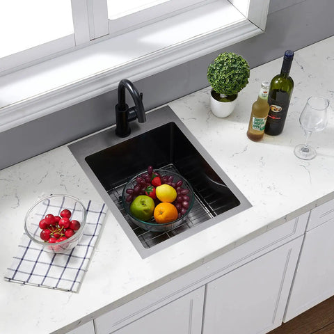Gunmetal Black Drop In Bar Sink For Small Kitchens And RVs, 15x20 Inch Stainless Steel 16 Gauge Top Mount Wet Bar Prep Sink With 10 Inch Deep Bowl, includes dish grid, installed in white countertop, surrounded by fruits and drinks.