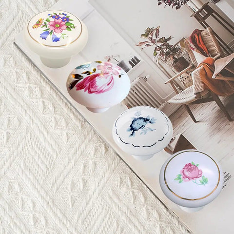 Ceramic Hand Painted Drawer Knobs Four Pack Vintage Floral Cabinet Pulls For Dresser Cupboard Wardrobe And Closet With Glossy White Flower Design And Smooth Operation, showing various floral designs.